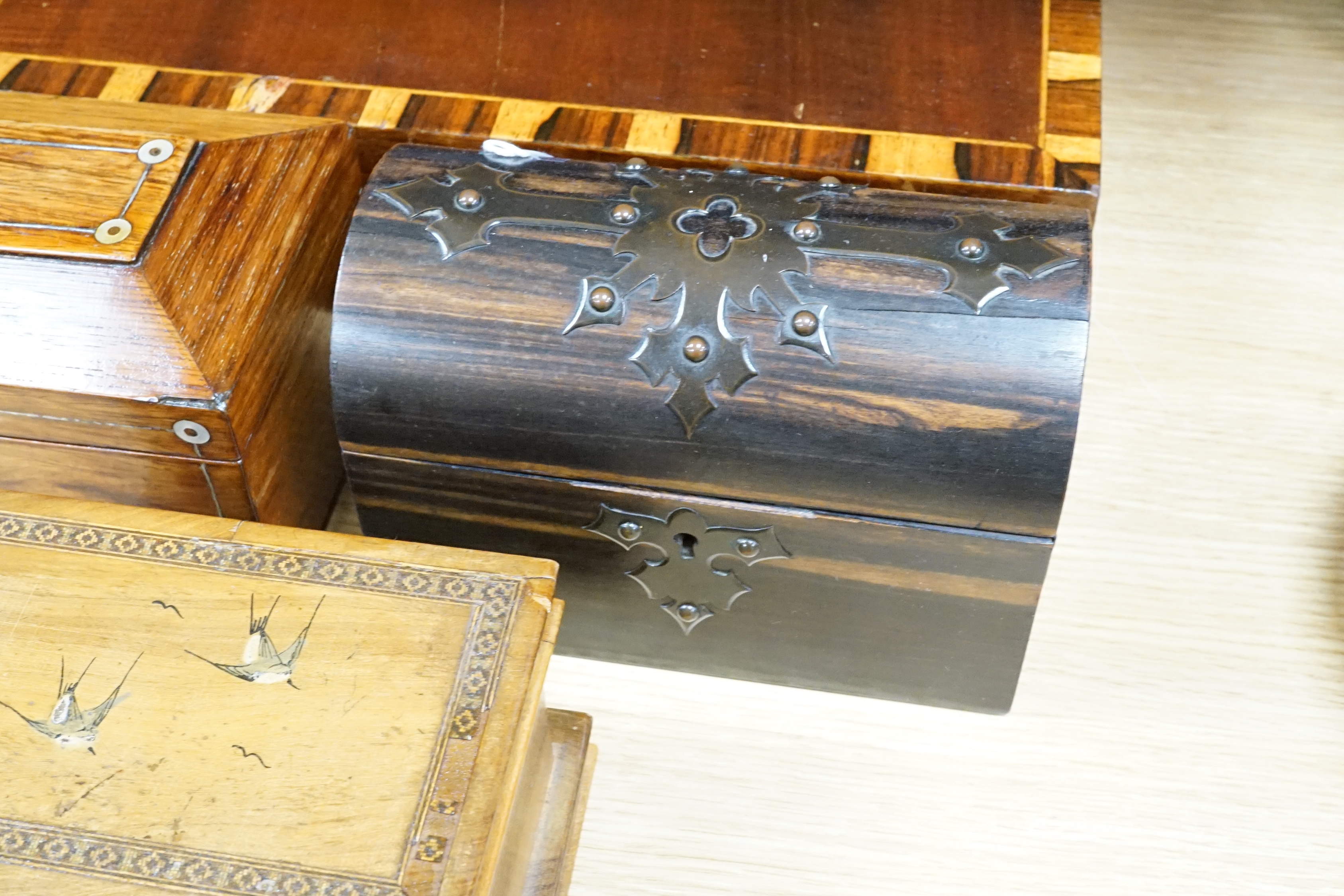 A Victorian coromandel stationary box, a rosewood tea caddy, an olive wood jewellery casket, a mahogany box and a chinoiserie panel, largest 41cm wide